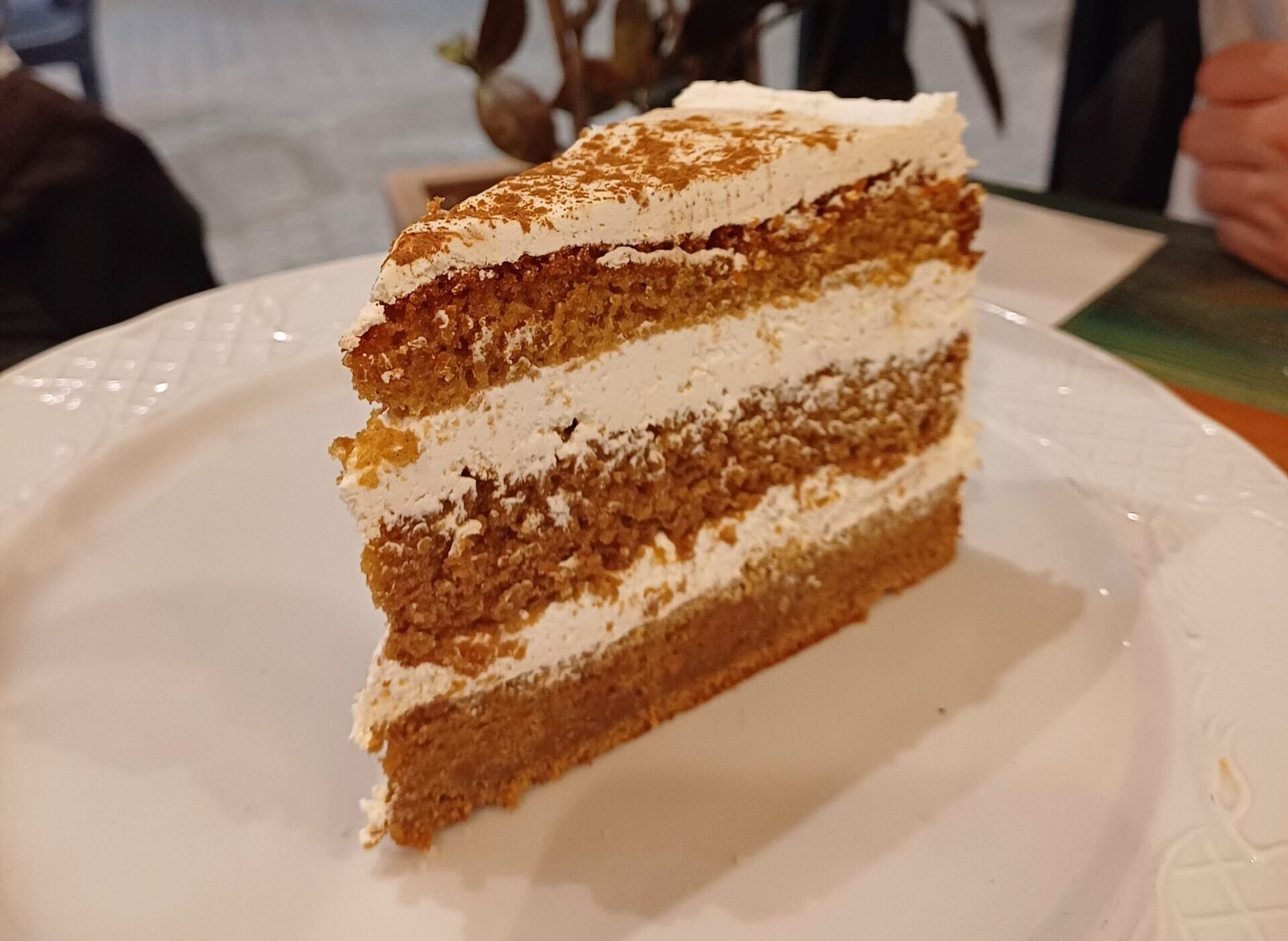 Slice of carrot cake on a white plate at depiKofino in Sevilla