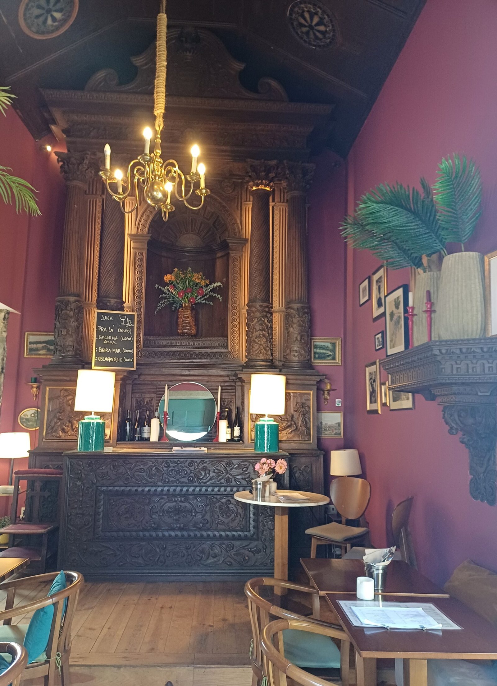 Original wooden altarpiece inside Capela Incomum, a wine bar housed in a converted chapel in Porto.