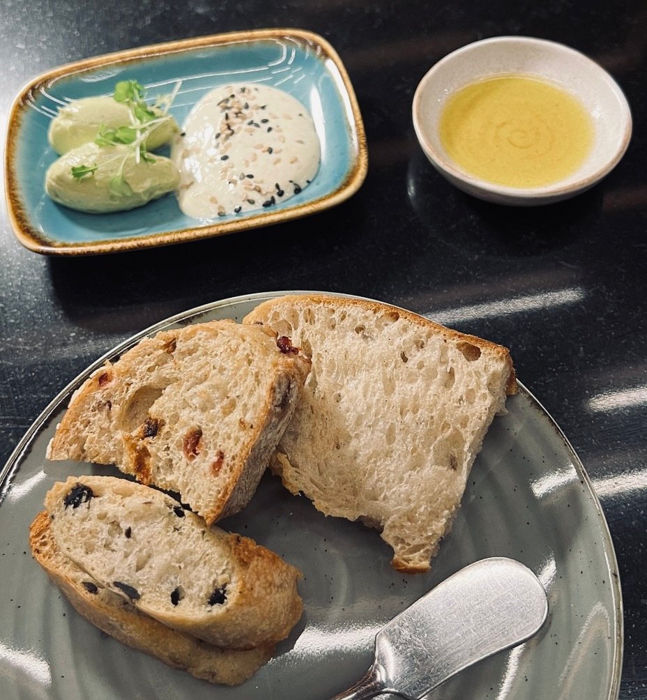 Assortment of breads, butters, and olive oil