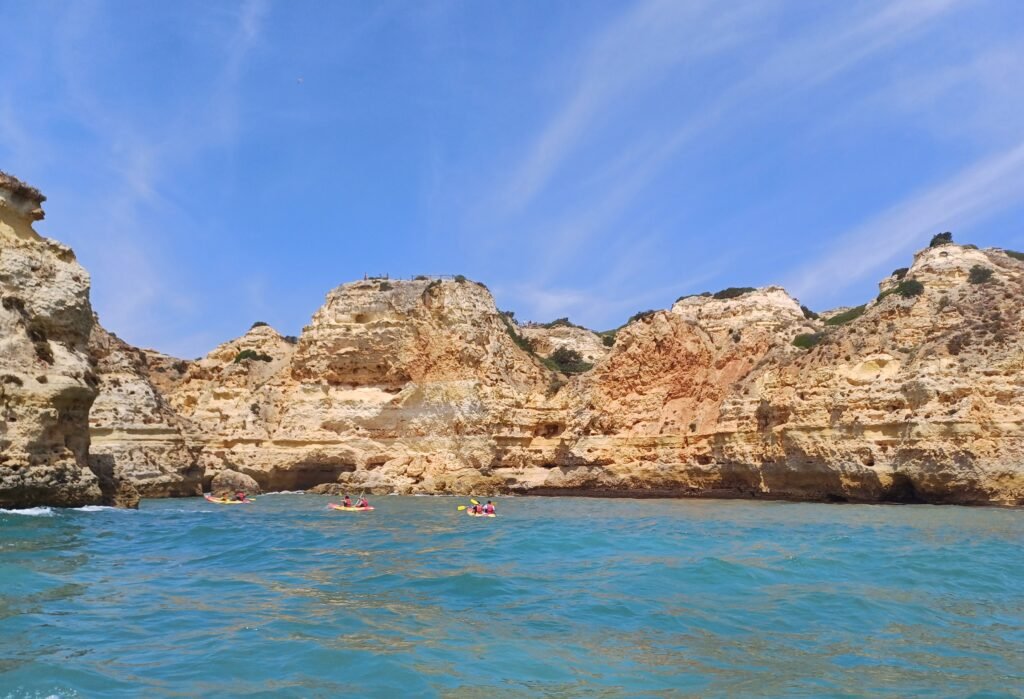 view from the water showcasing the blue ocean and rocky formations Algarve coast