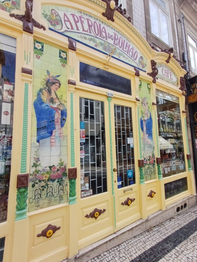 Shop window of A Pérola do Bolhão, featuring traditional Portuguese goods and its stunning, historic facade.