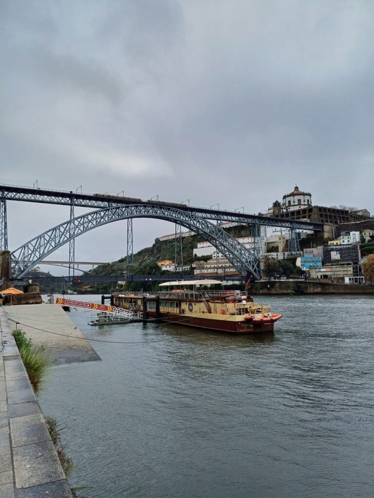 View of Dom Luís I Bridge spanning the Douro River, seen from the Ribeira district in Porto, Portugal.