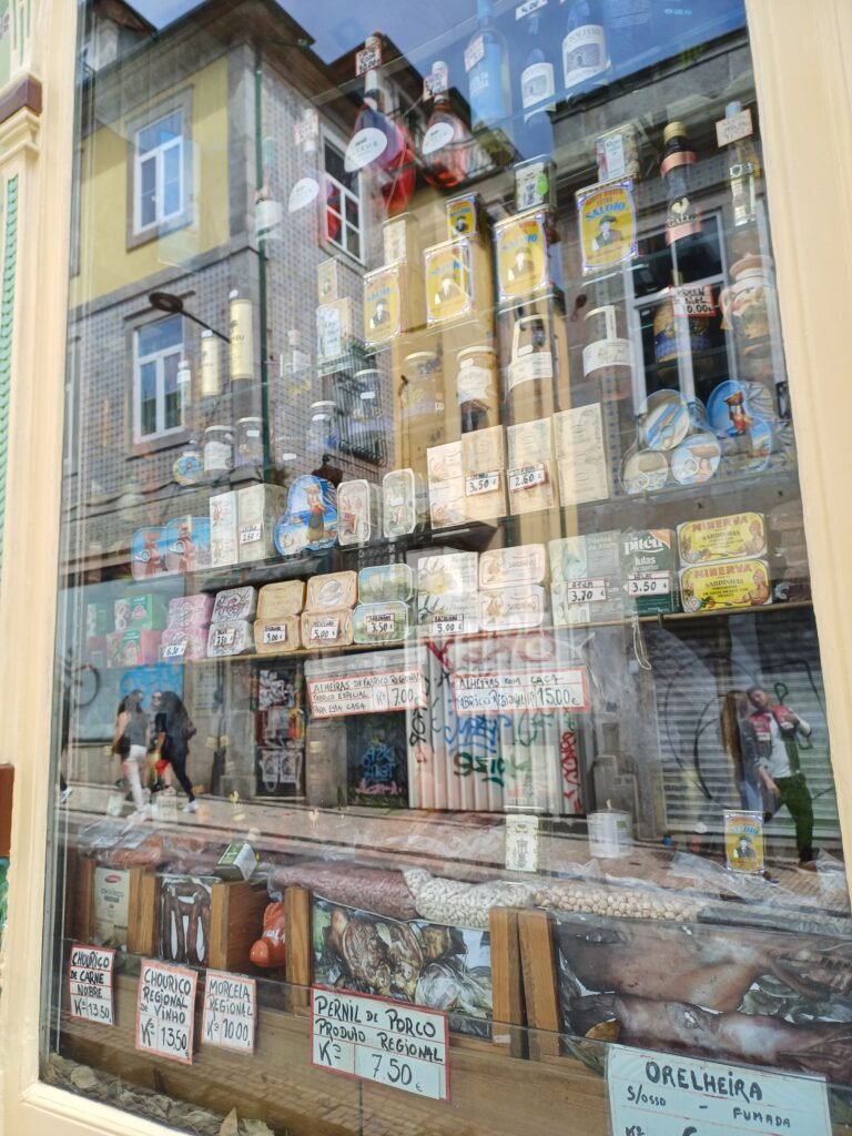 Shop window of A Pérola do Bolhão in Porto, showcasing traditional Portuguese products and ornate facade