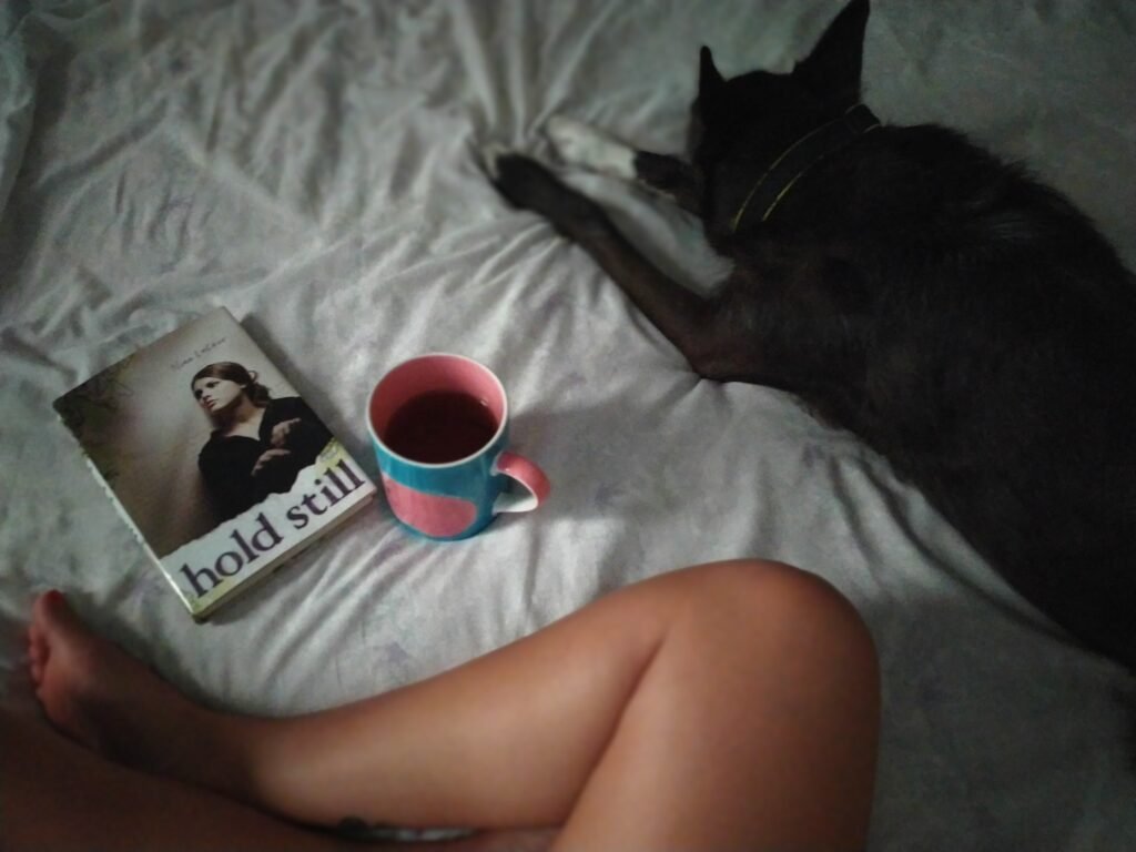 reading with dog while having tea