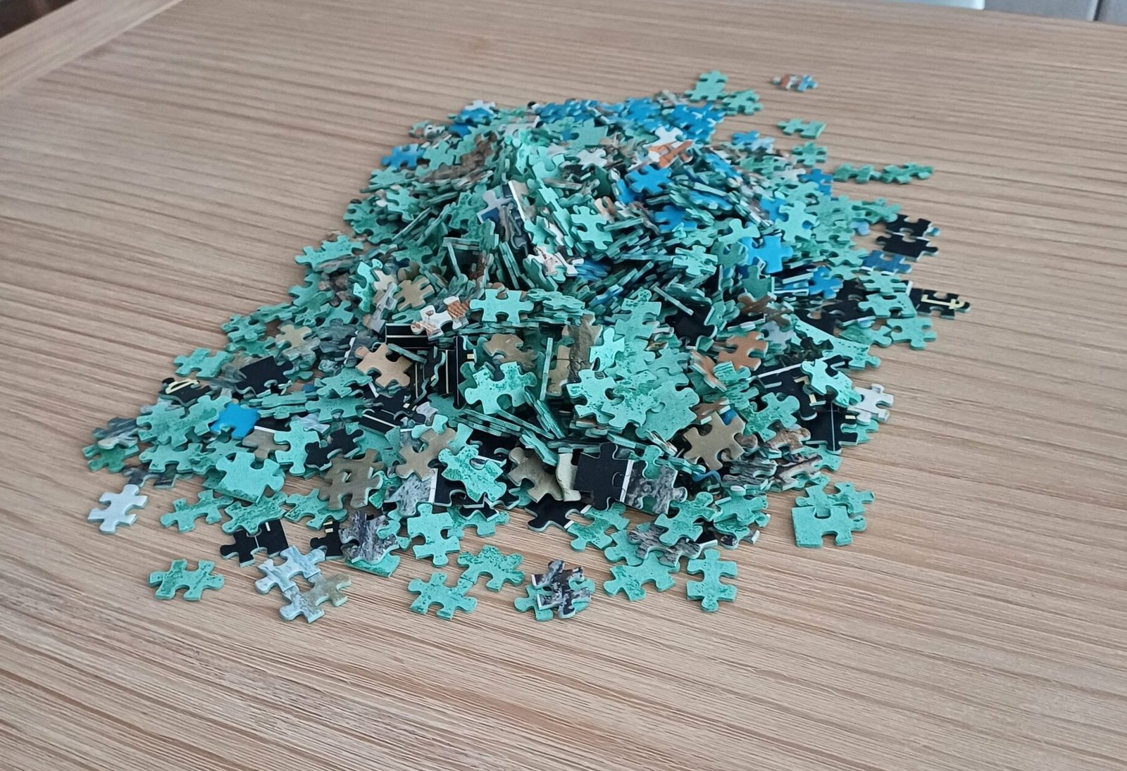 jigsaw puzzle pieces on top of a dining table