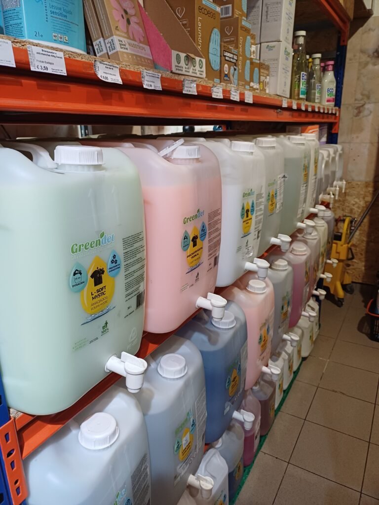 Bulk detergent area at Maçaroca, featuring refill stations where customers can fill their own containers with eco-friendly cleaning products, reducing plastic waste