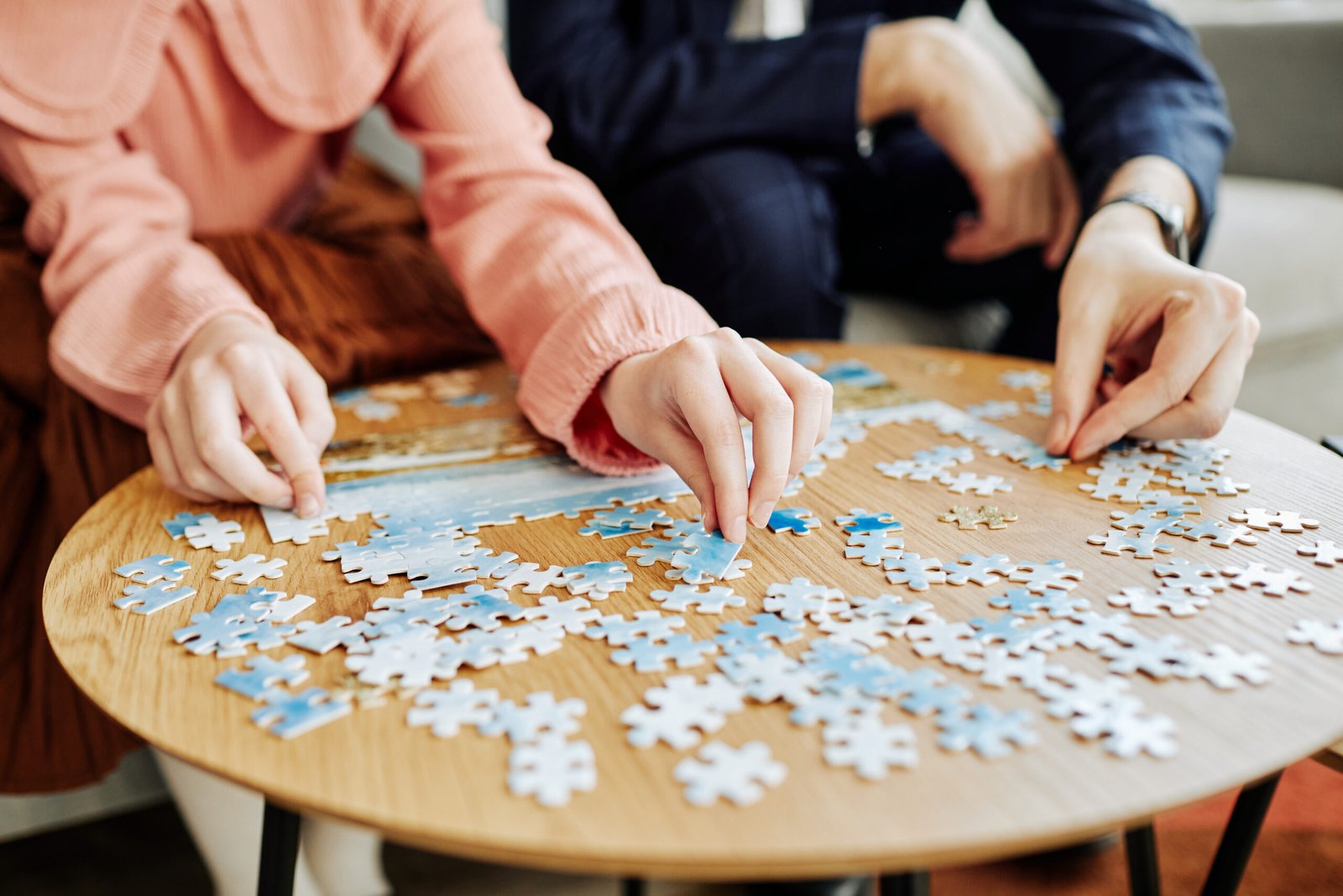 people working on a jigsaw puzzle together