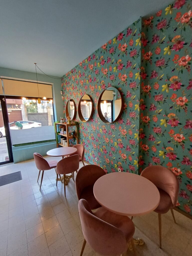 Bright and colorful interior of Comfort Cakes café, featuring vibrant wall art and cozy seating.